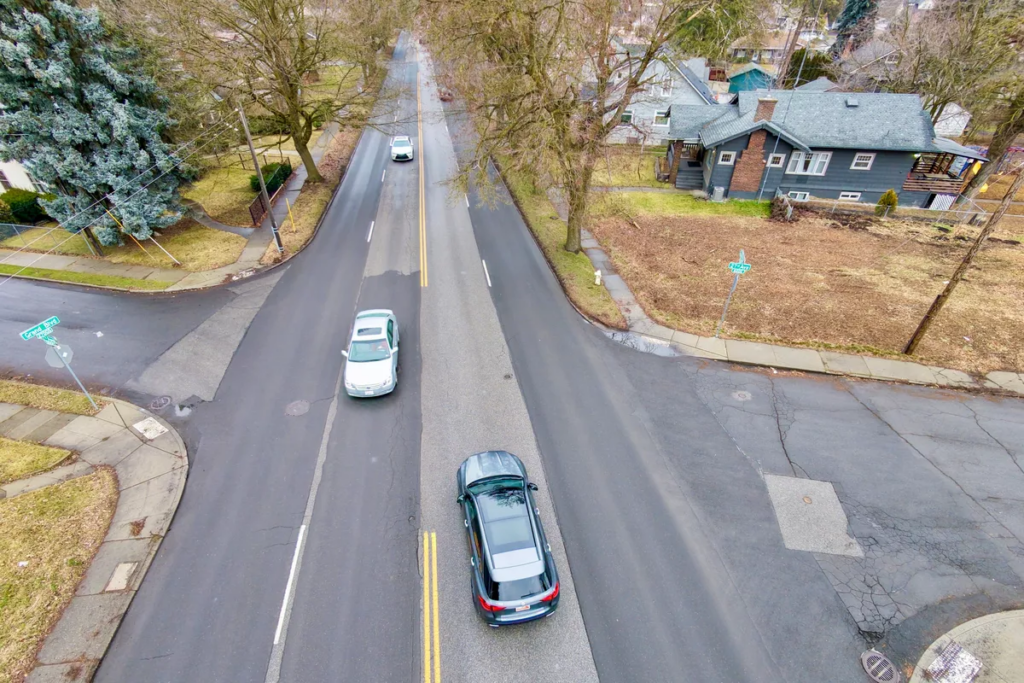 Aerial photo of 3 cars traveling on Grand Boulevard. 
